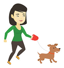 Image showing Young woman walking with her dog.