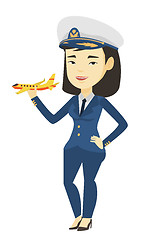 Image showing Cheerful airline pilot with model airplane.