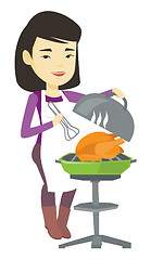 Image showing Woman cooking chicken on barbecue grill.