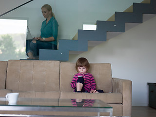 Image showing little girl playing games on smartphone