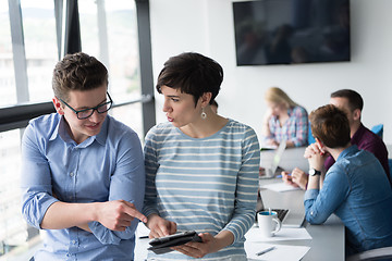 Image showing Two Business People Working With Tablet in office