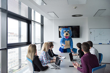 Image showing boss dresed as bear having fun with business people in trendy of