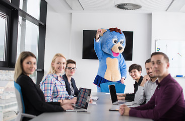 Image showing boss dresed as bear having fun with business people in trendy of