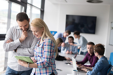 Image showing Two Business People Working With Tablet in office