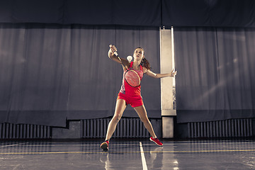 Image showing Young woman playing badminton at gym