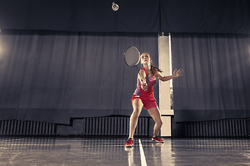 Image showing Young woman playing badminton at gym