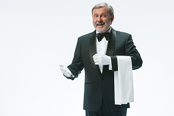 Image showing Senior waiter holding white towel