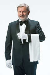 Image showing Senior waiter holding white towel