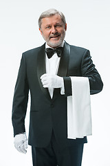 Image showing Senior waiter holding white towel