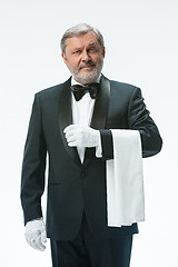 Image showing Senior waiter holding white towel