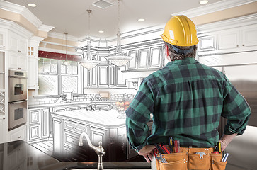 Image showing Male Contractor with Hard Hat and Tool Belt Looking At Custom Ki