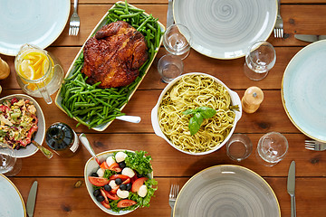 Image showing various food on served wooden table