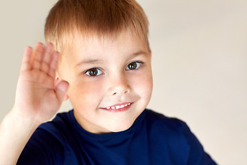 Image showing portrait of happy smiling little boy waving hand