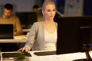 Image showing businesswoman at computer working at night office