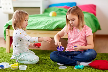 Image showing sisters with modelling clay or slimes at home