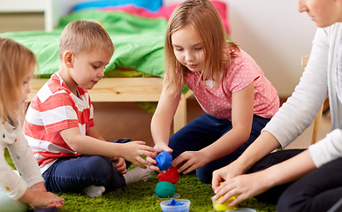 Image showing kids and mother with modelling clay or slimes