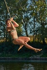 Image showing Rope swing river jump