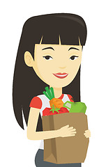 Image showing Happy woman holding grocery shopping bag.