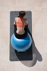 Image showing woman doing exercise with pilates ball top view