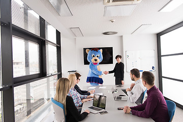 Image showing boss dresed as bear having fun with business people in trendy of