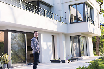 Image showing man in front of his luxury home villa