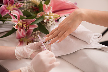 Image showing Woman hands receiving a manicure