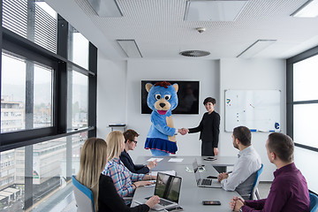 Image showing boss dresed as bear having fun with business people in trendy of