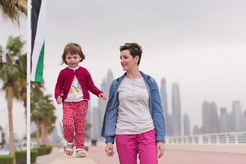 Image showing mother and cute little girl on the promenade