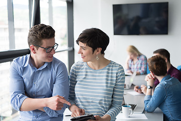 Image showing Two Business People Working With Tablet in office