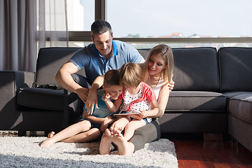 Image showing happy young couple spending time with kids