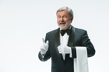 Image showing Senior waiter holding white towel