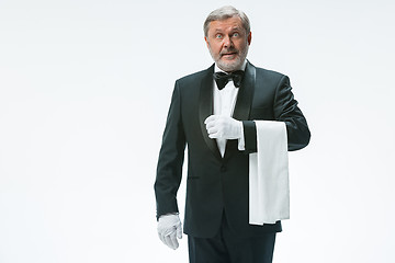 Image showing Senior waiter holding white towel