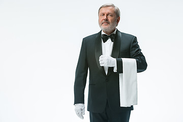 Image showing Senior waiter holding white towel