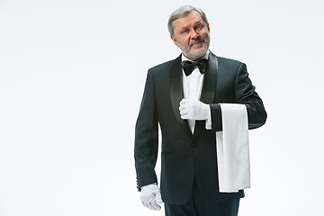 Image showing Senior waiter holding white towel