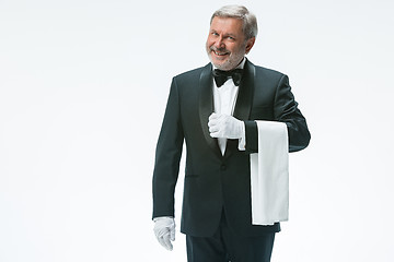 Image showing Senior waiter holding white towel