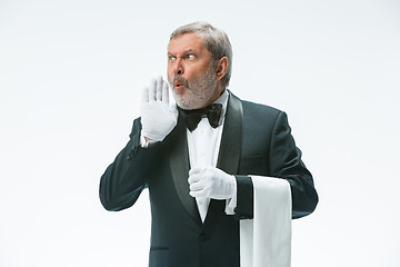 Image showing Senior waiter holding white towel