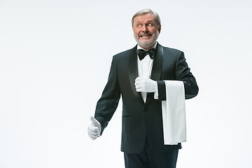 Image showing Senior waiter holding white towel