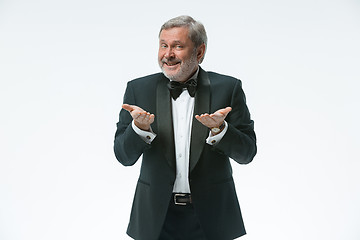 Image showing older businessman in a suit with a bow tie, isolated over white