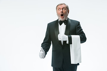 Image showing Senior waiter holding white towel