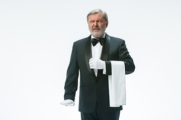 Image showing Senior waiter holding white towel