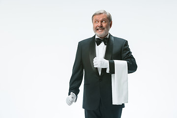 Image showing Senior waiter holding white towel