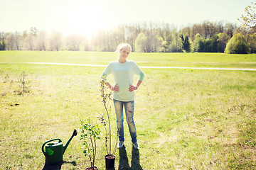 Image showing happy young volunteer woman outdoors