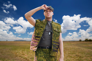 Image showing soldier in military uniform over sky background