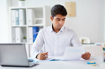 Image showing businessman working with papers at office