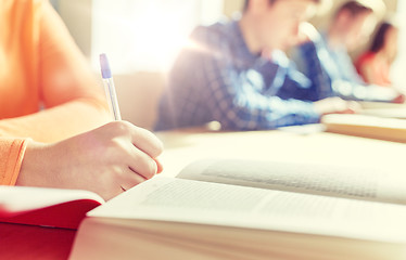 Image showing close up of students with book writing school test