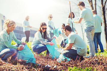 Image showing volunteers with garbage bags cleaning park area