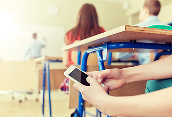 Image showing student boy with smartphone texting at school