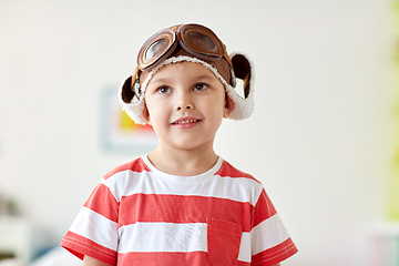 Image showing happy little boy in pilot hat at home