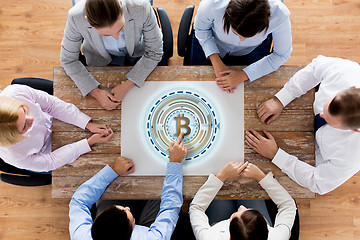 Image showing business team at table with bitcoin icon