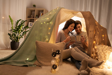 Image showing couple drinking coffee or tea in kids tent at home